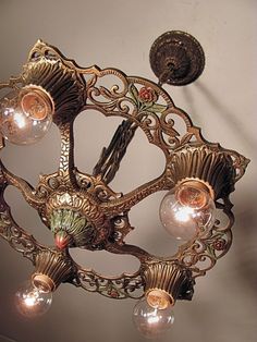 an ornate chandelier hanging from the ceiling in a room with light bulbs on it