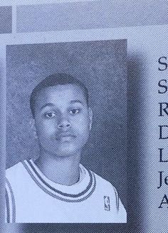 an old photo of a young man in a basketball uniform with the school's name on it