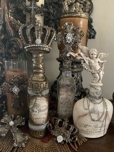 there are many different vases on the table with pearls and chains around them,