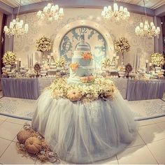 an elaborately decorated table in a fancy room with chandeliers and flowers on it