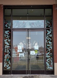 the glass doors are decorated with designs on them