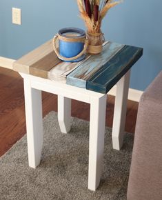 a wooden table with a blue bowl on it and a plant sitting on top of it