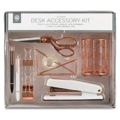 the desk accessory kit includes scissors, pens and other items in its packaging box on a white background