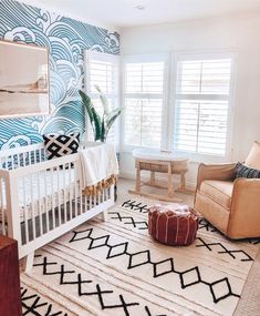 a baby's room with blue and white wallpaper