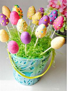 easter cake pops in a blue pot with grass and sprinkles