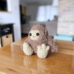 a small stuffed animal sitting on top of a wooden table