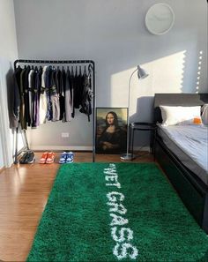 a bedroom with a green rug that says football on the floor next to a bed