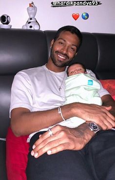 a man holding a baby in his lap