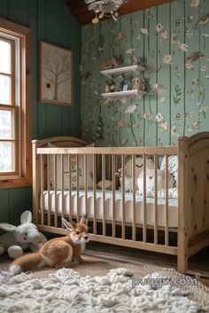 a baby's room with green walls and floral wallpaper