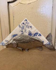 a fish napkin holder sitting on top of a table