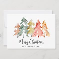 a christmas card with watercolor trees on it