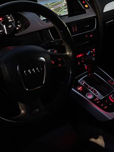 the interior of a car with dashboard lights, steering wheel controls and dash light displays