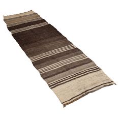 a brown and white striped rug on a white background with no one around it,