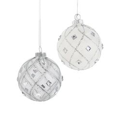 two glass ornaments hanging from chains on a white background