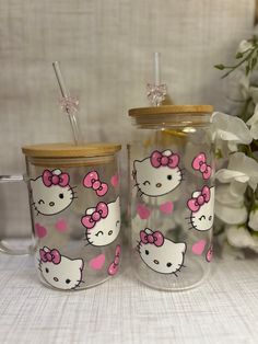 two glass cups with hello kitty designs on them