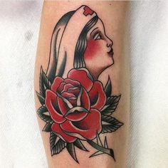 a woman with a rose tattoo on her leg