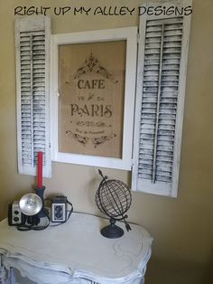 there is a table with some items on it in front of a window that says cafe de paris