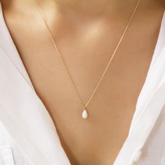 "Delicate and minimalist drop shaped 14K gold necklace rests on the model's neck. It is a handmade necklace with a dainty, white colored Opal Stone on the chain.  Jewelry for women that will make your day beautiful, specially designed. white opal stone has been carefully designed for you and added to our necklace, which is a stylish and eye-catching model.  Our product weighs 1.46 gr and the chain length is 42 cm.  All of our products has the stamp \"585\" on them. (which states that this is rea Minimalist 14k Gold Drop Necklace For Formal Occasions, White 14k Gold Filled Teardrop Necklace, White Teardrop 14k Gold Necklaces, Elegant Teardrop 14k Gold Charm Necklace, Delicate Gold Pear-shaped Necklace, Minimalist Pear-shaped Necklace For Formal Occasions, Delicate Pear-shaped Gold Necklace, Pear-shaped Minimalist Necklace For Formal Occasions, Formal Pear-shaped Minimalist Necklace