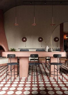 a dining room with pink walls and flooring