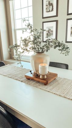 a table with a vase and candle on it