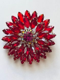 This is an absolutely beautiful unsigned beauty ruby red rhinestone flower pin brooch. This piece holds many attributes of Juliana jewelry however I cannot document it in the database. This pin measures 2 3/8 inches wide. It is multi tiered. Features beautiful red open back rhinestones. The center features a larger stone surrounded by a ring of red aurora borealis rhinestones This item is an excellent preowned vintage condition with normal wear for the age. The pinpointed sharp in the role clasp Vintage Red Pins For Party, Red Formal Costume Jewelry Brooches, Red Aurora Borealis, Juliana Jewelry, Antique Costume Jewelry, Amethyst Crystal Necklace, Vintage Rhinestone Jewelry, Rhinestone Flower, Brooch Jewelry