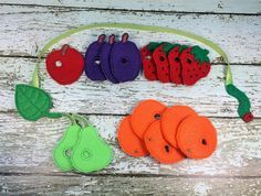 an assortment of felt fruits and vegetables on a string