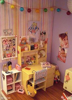 a doll house with furniture and accessories on the floor in front of a striped wall