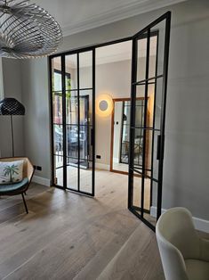 an empty living room with wooden floors and glass doors