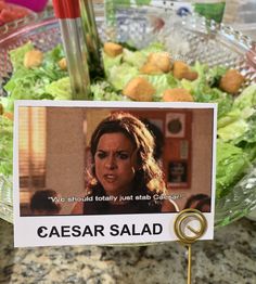 there is a salad in the bowl with an ad on it that says caesar salad