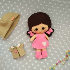 there is a small doll next to a hat and other items on the table together