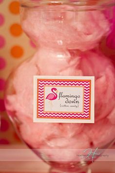 pink cotton candy in a glass jar with a label on the top that says flamingo dawn