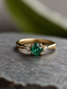 a green ring sitting on top of a stone