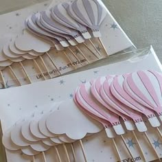 some pink and white hot air balloons on sticks