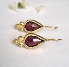 Gold Garnet earrings, Teardrop earrings, Red Gemstone Earrings, Antique earrings, 14k gold earrings, January Birthstone Earrings, Vintage These Vintage inspired Teardrop earrings were designed and set with beautiful, deep red pear shaped Garnets. The Gold Garnet earrings are 100% handmade and are romantic, elegant and beautiful. The earrings are shaped as teardrops, with a triangle of 3 golden dots at the edge of every such drop. The January Birthstone earrings are a great gift for you or your J Elegant Garnet Teardrop Earrings, Elegant Pierced Garnet Earrings, Gold Teardrop Garnet Earrings, Faceted Garnet Earrings In Gold, Gold Garnet Faceted Earrings, Red Pear, Earrings Teardrop, Earrings Antique, Birthstone Earrings