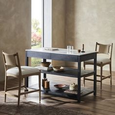 a dining table with two chairs and a shelf in front of it on top of a hard wood floor