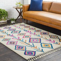 a living room with a couch, chair and rug