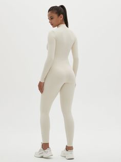 Why We Love It: The Hannah Long Sleeve Zipper Bodysuit is the epitome of sleek, modern activewear. This bodysuit combines functionality with a streamlined design, ensuring you look and feel your best whether you're at the gym or out and about. Fit and Features: Front Zipper Detail: The front zipper allows for easy wear and adjustability, adding a chic element to this versatile piece. Long Sleeves with Thumbholes: Provides added coverage and a secure fit, perfect for cooler weather or intense workouts. Buttery Soft Fabric: This bodysuit feels like a second skin, offering unmatched comfort and flexibility. High Performance: The four-way stretch material ensures maximum freedom of movement, making it ideal for any activity. Moisture-Wicking Technology: Keeps you dry and comfortable, no matter Solid Fitted Sportswear Bodysuit, Fitted Athleisure Bodysuit With Thumbholes, High Stretch Elastane Unitard For Gym, Second-skin Bodysuit For Loungewear In Athleisure Style, Second-skin Athleisure Bodysuit For Loungewear, High Stretch Athleisure Bodysuit For Loungewear, Fitted Solid Color Unitard For Athleisure, Sleek Stretch Bodysuit For Sports, Sleek Sports Bodysuit Stretch Fit