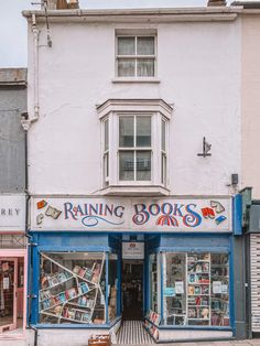 a book store on the corner of a street in front of a building with many bookshelves