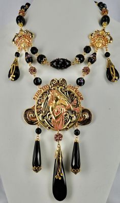 Stunning black & Pink Art Nouveau Lady Necklace, Gold plated with hand painted patina, Onyx and vintage Czech glass drops, Facetted Onyx beads, Gorgeous Lampwork Venetian wedding cake & Czech beads, Vintage Swarovski rhinestone beads, Facetted crystal beads, hand beaded chain, signed CZECHO top metal components, 1920s Czech bead caps, lobster clasp with hand closure, Absolutely Frivolous tag and extender chain. Black Jewelry With Artistic Design, Black Artistic Jewelry, Artistic Black Enamel Jewelry, Artistic Black Collectible Jewelry, Black Hand Painted Pendant Jewelry, Ornate Handmade Black Necklace, Handmade Black Enamel Necklace, Hand Painted Black Pendant Jewelry, Vintage Black Hand Painted Jewelry