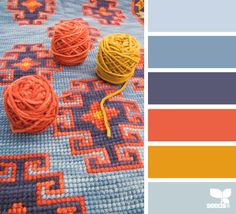 the color scheme is orange, blue, and gray with an assortment of balls of yarn