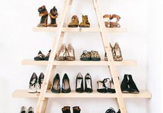 there are many pairs of shoes on the shelf in front of each other and one is wearing high heels