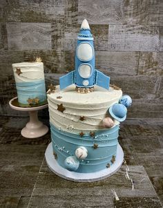 a blue and white cake sitting on top of a table