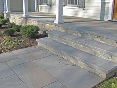 an outdoor patio with steps leading up to the front door