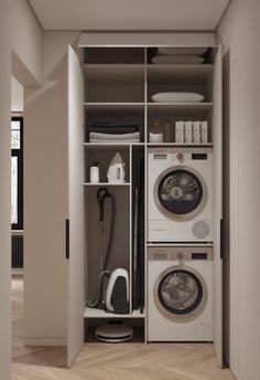 a washer and dryer sitting in a closet next to each other on top of a hard wood floor