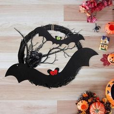 halloween decorations on the floor with bats and pumpkins