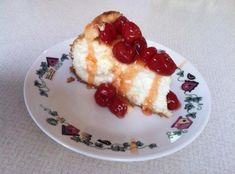 a piece of cheesecake with cherries is on a plate