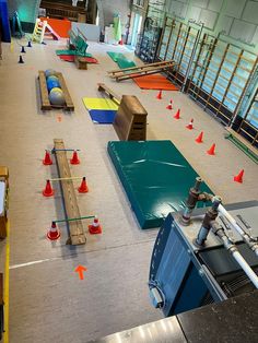 an indoor area with various obstacles and cones