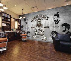 a barber shop with two chairs and a mural on the wall behind it that says gentlemen