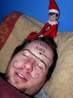 a man laying on top of a bed next to an elf with his eyes closed