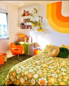 a bed room with a neatly made bed and orange chairs